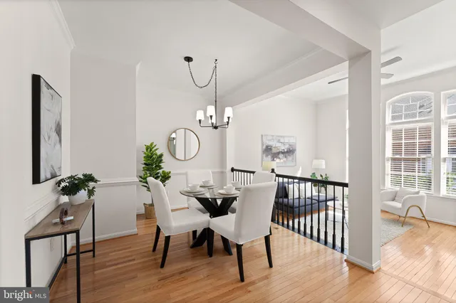 a kitchen with a refrigerator a white stove top oven and white cabinets