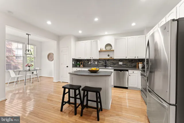 a kitchen with stainless steel appliances a sink and a stove