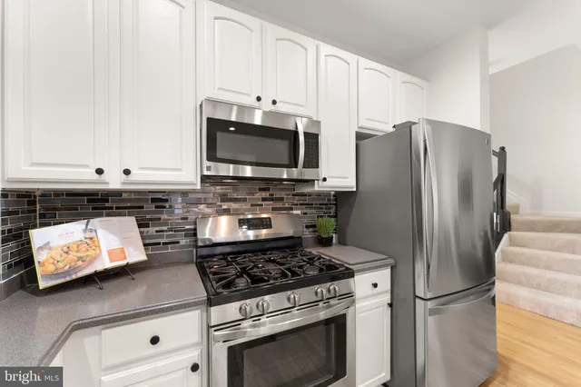 a view of a wooden deck with large trees