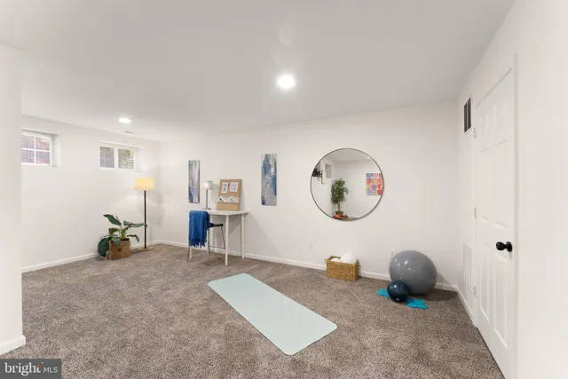 a view of a house with a yard and sitting area