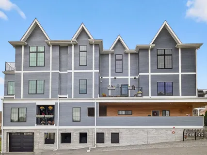 a front view of a residential apartment building with a yard