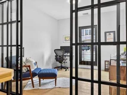a living room with furniture and a chair