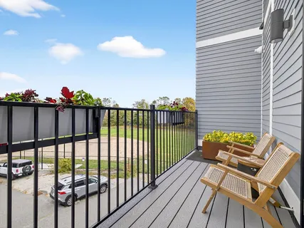 a large bed sitting in a bedroom next to a window