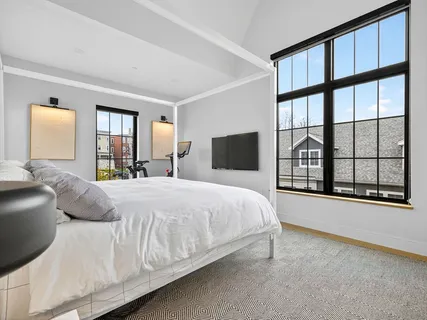 a spacious bedroom with a bed and window