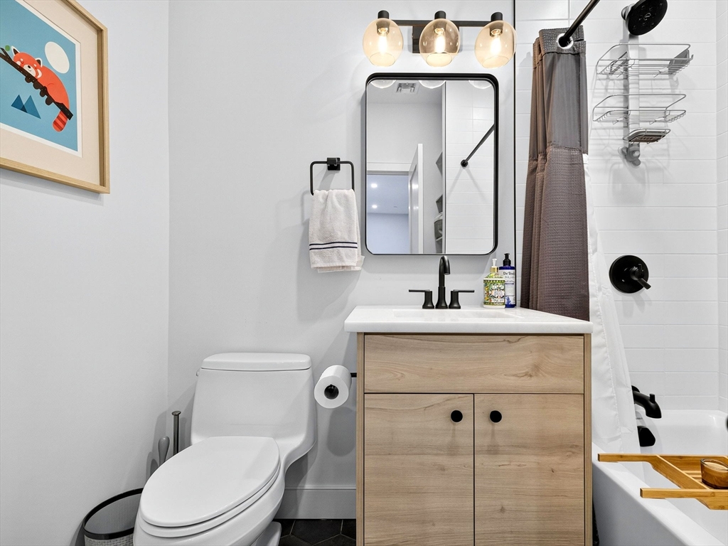 4 Payne Street, Unit 5 Boston, MA 02122 - Photo 35 of 38 a bathroom with a sink a toilet and shower