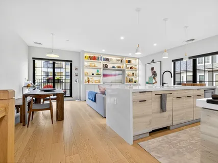 a kitchen with stainless steel appliances kitchen island granite countertop a stove and a sink
