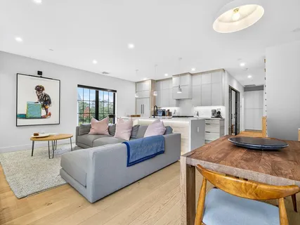 a living room with kitchen island furniture and a wooden floor