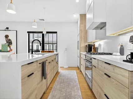 a large kitchen with a sink and cabinets