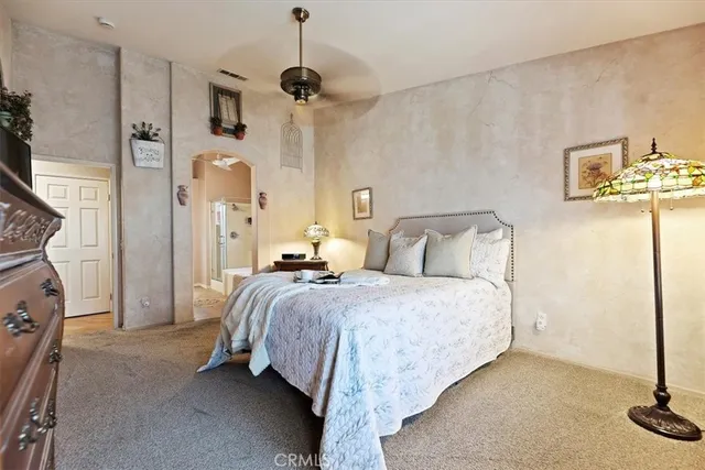 a bedroom with a bed and a mirror