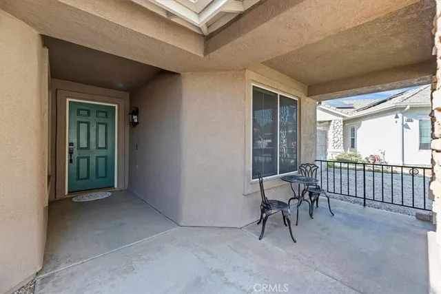 a view of a room that has a bed and a table in it