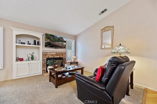 a living room with furniture fireplace and flat screen tv