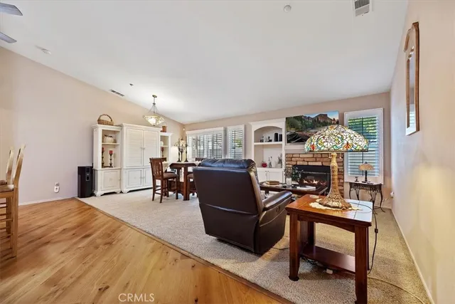 a living room with furniture a dining table and a piano table