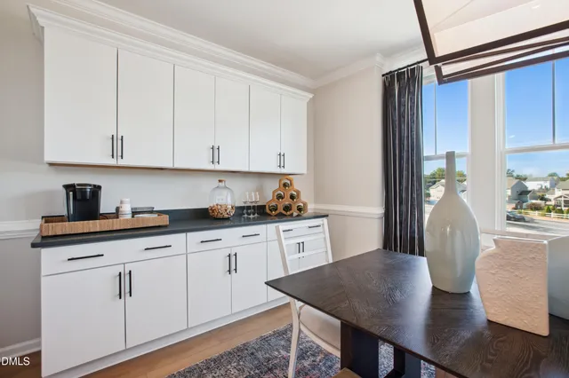 a kitchen with granite countertop white cabinets white appliances a sink and dishwasher