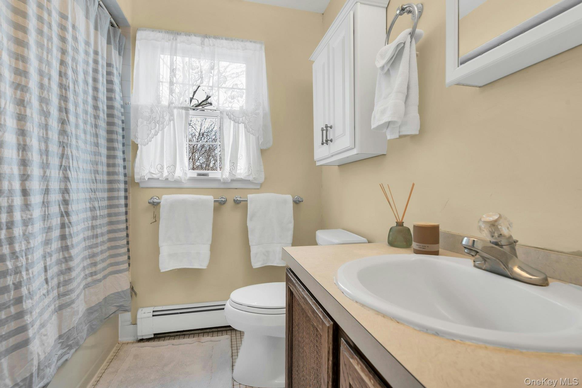 5845 North Bayview Road Southold, NY 11971 - Photo 18 of 26 2nd floor bathroom featuring tub, shower, vanity and tiled flooring