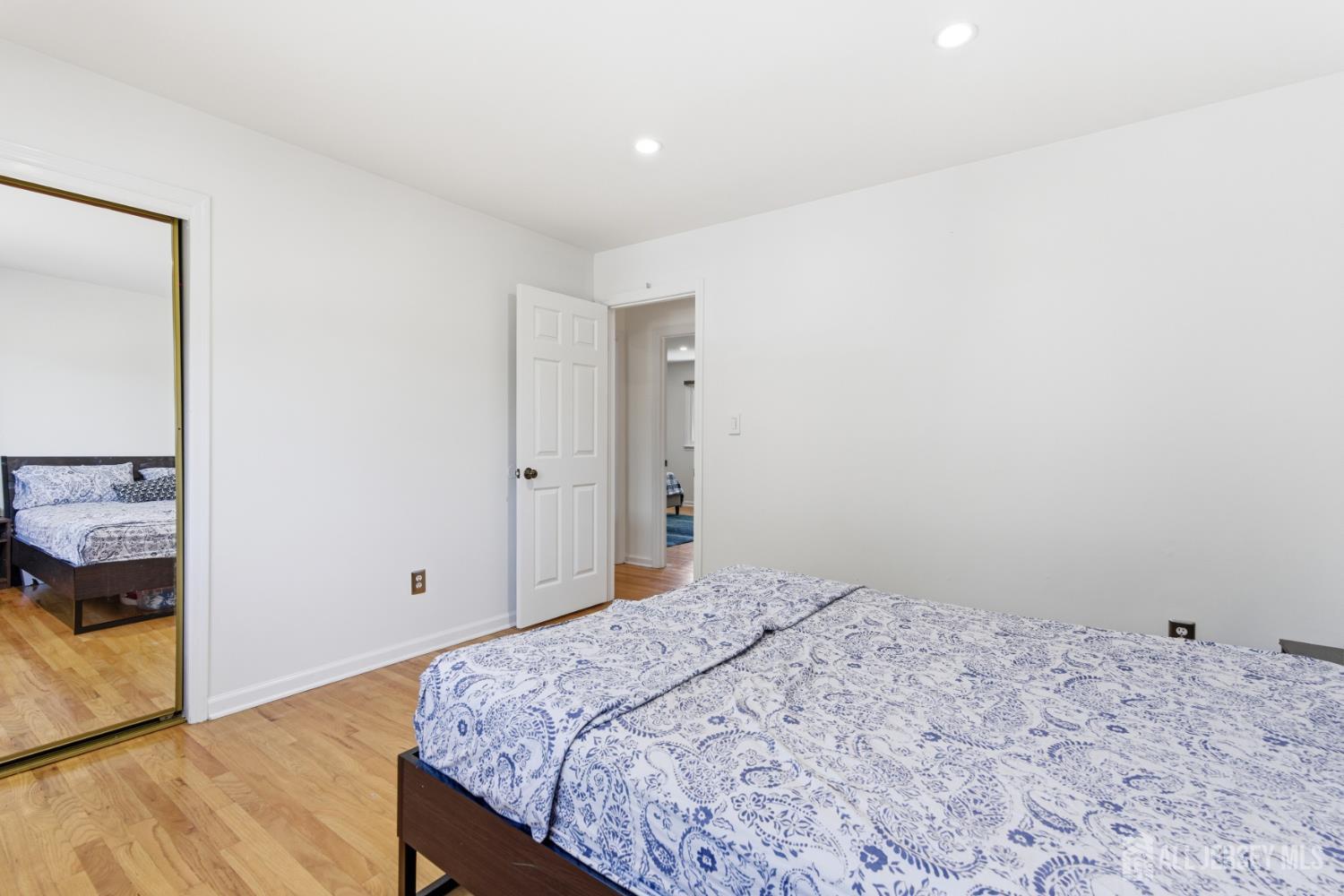 213 Normandy Road Edison, NJ 08820 - Photo 33 of 45 a bedroom with a bed and a mirror