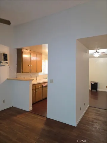 a view of a kitchen with a sink and dishwasher with wooden floor