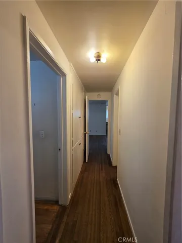 a room with a wooden floor and brick walls