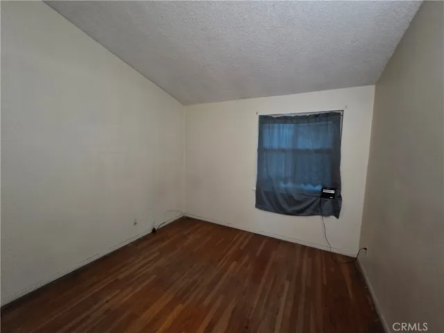 a view of a living room with furniture and wooden floor