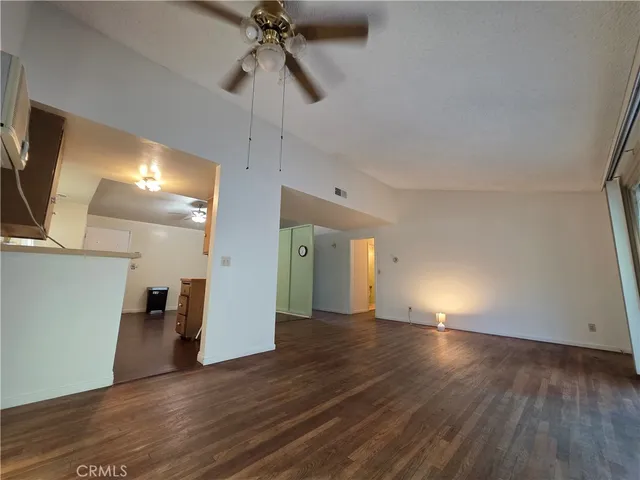 a front view of a house with a yard and potted plants