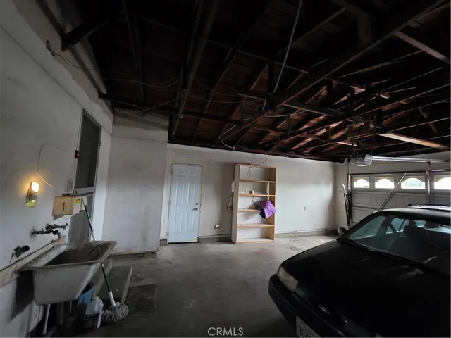 a yellow house with a flower garden in front of it