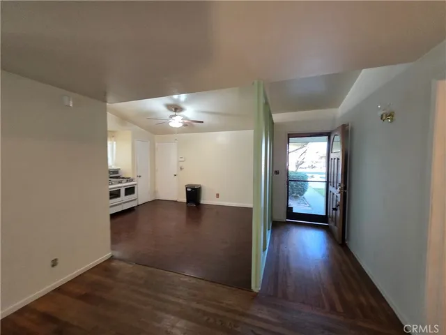 a view of an empty room and wooden floor