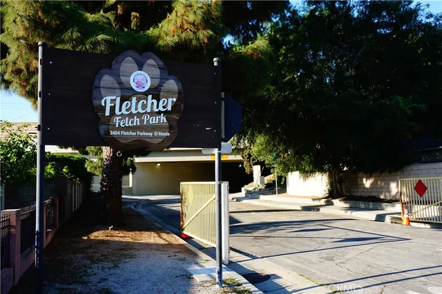 a front view of a house with a garden and parking