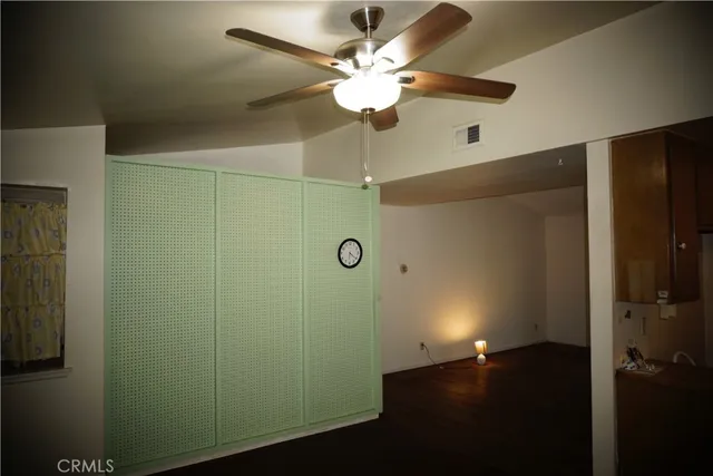 an empty room with wooden floor and closet