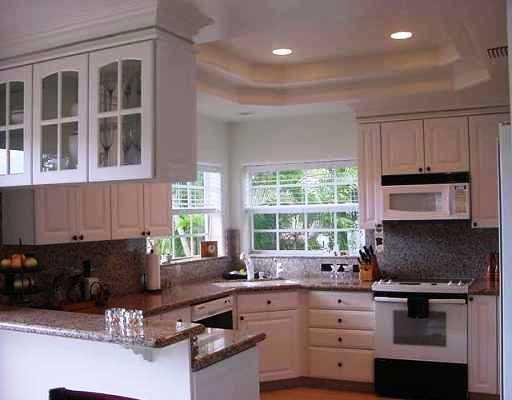 800 Southwest Salerno Road Stuart, FL 34997 - Photo 4 of 8 a kitchen with granite countertop a stove a sink and a microwave