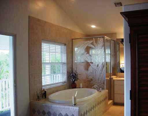 800 Southwest Salerno Road Stuart, FL 34997 - Photo 6 of 8 a bath tub sitting in a bathroom next to a window