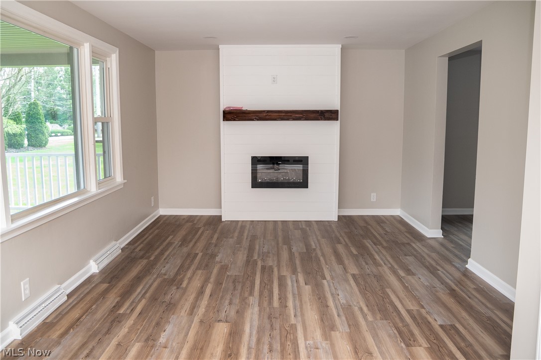 6666 Clingan Road Youngstown, OH 44514 - Photo 11 of 41 Living room with new LVT flooring, paint, new electric fireplace with remote