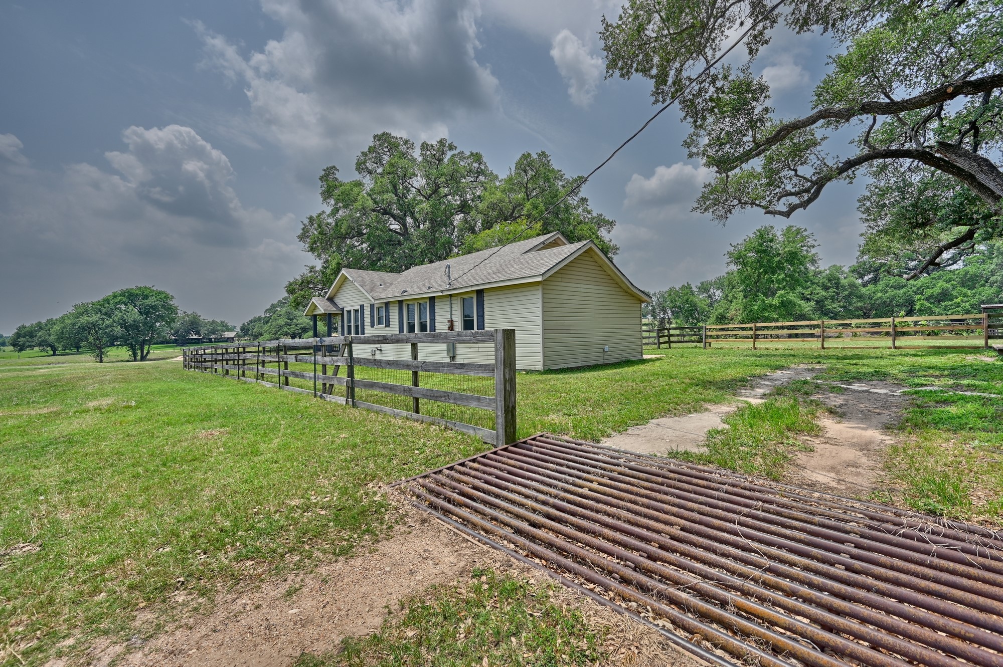 7009 Sandy Hill Road Brenham, TX 77833 - Photo 16 of 41 a view of a house with backyard and a tree