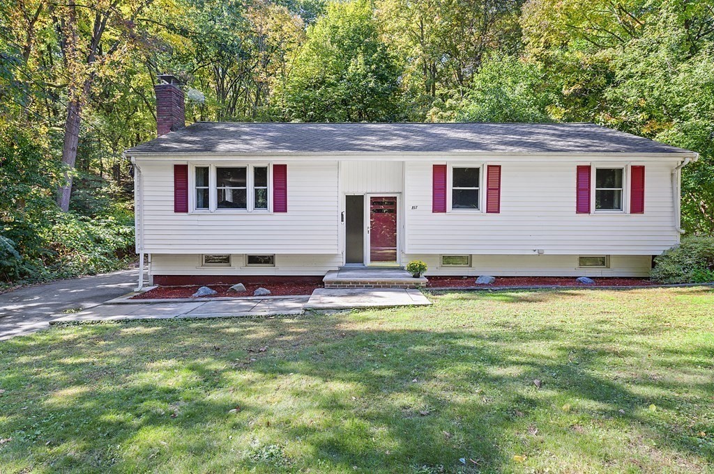 157 Spring Street Stoneham, MA 02180 - Photo 1 of 34 a front view of a house with a yard and garage