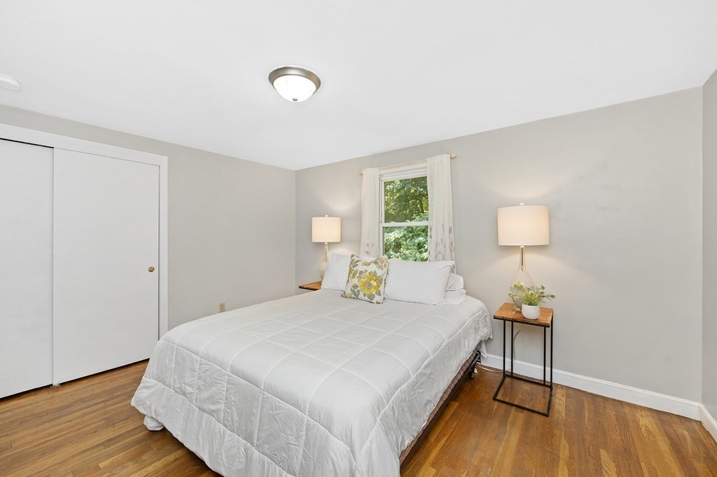 157 Spring Street Stoneham, MA 02180 - Photo 11 of 34 a bedroom with a bed and a lamp