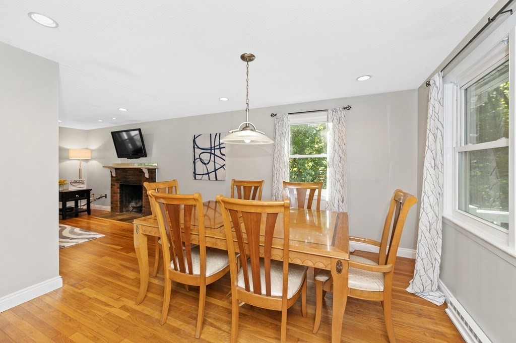 157 Spring Street Stoneham, MA 02180 - Photo 13 of 34 a living room with furniture a dining table and a large window