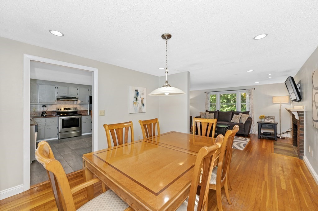 157 Spring Street Stoneham, MA 02180 - Photo 14 of 34 a living room with furniture kitchen view and a chandelier