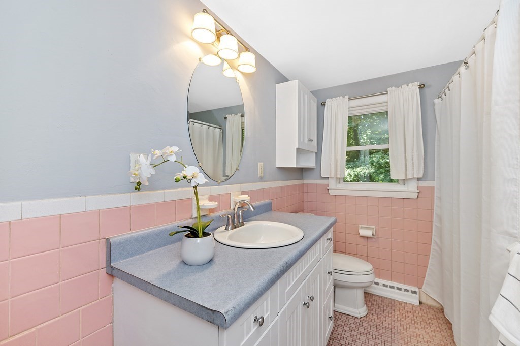 157 Spring Street Stoneham, MA 02180 - Photo 23 of 34 a bathroom with a sink a toilet and a mirror