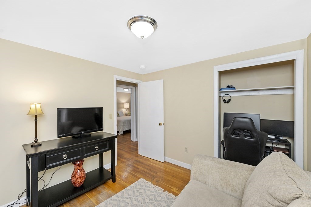 157 Spring Street Stoneham, MA 02180 - Photo 26 of 34 a living room with furniture and a flat screen tv