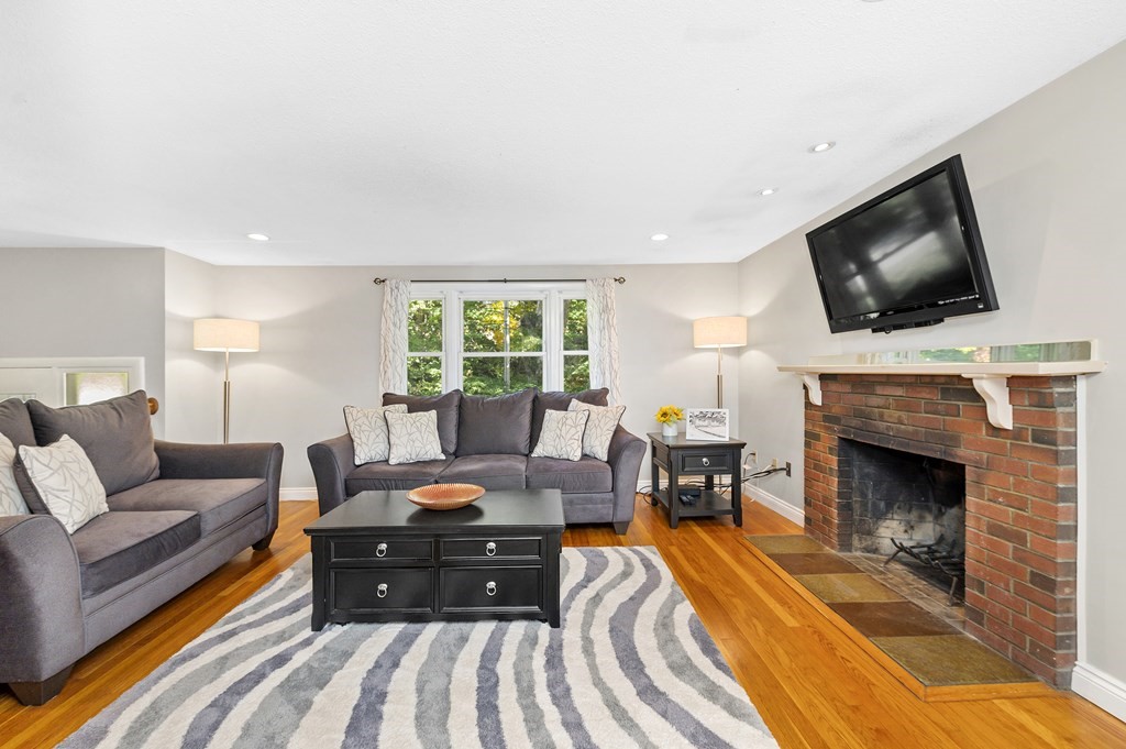 157 Spring Street Stoneham, MA 02180 - Photo 3 of 34 a living room with furniture and a fireplace