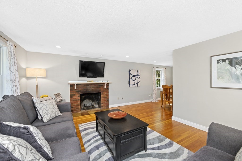 157 Spring Street Stoneham, MA 02180 - Photo 6 of 34 a living room with furniture and a fireplace