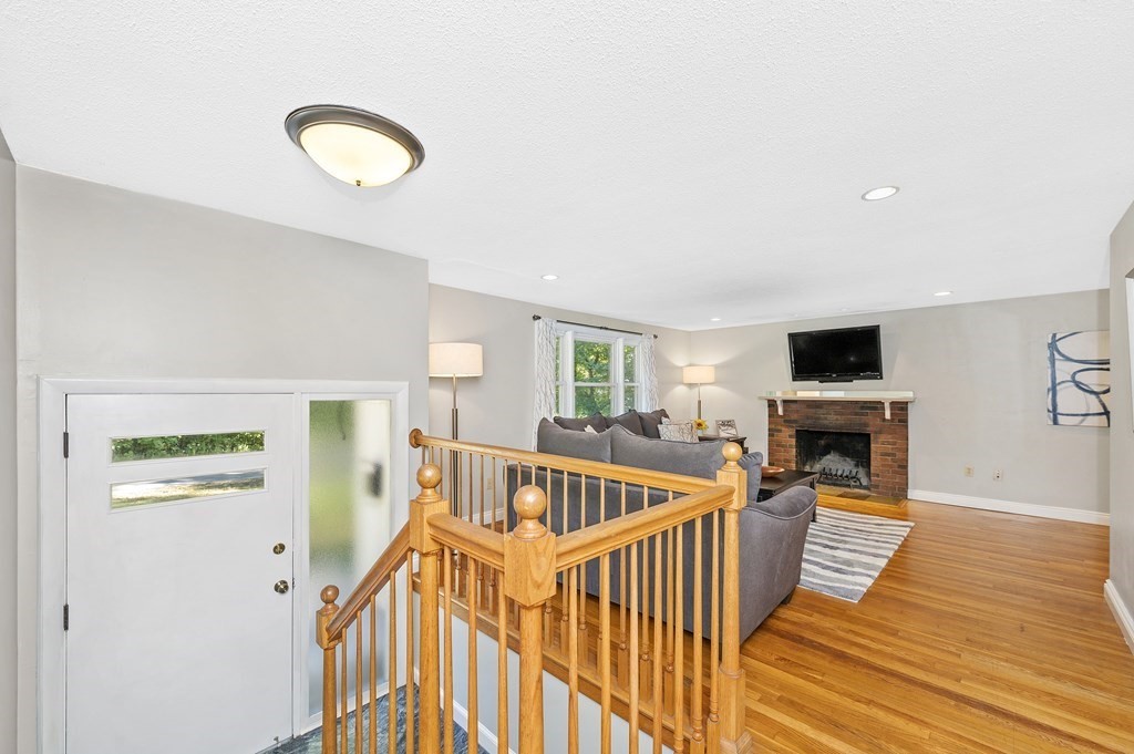 157 Spring Street Stoneham, MA 02180 - Photo 8 of 34 a view of a livingroom with furniture hardwood floor and staircase