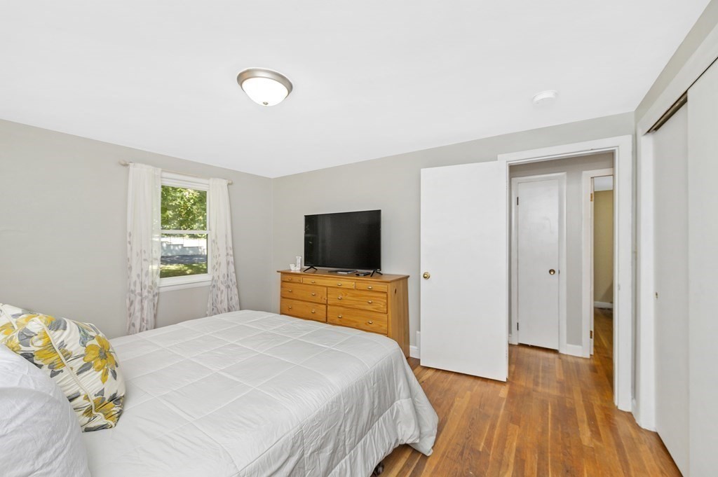 157 Spring Street Stoneham, MA 02180 - Photo 10 of 34 a bedroom with a bed and a flat screen tv