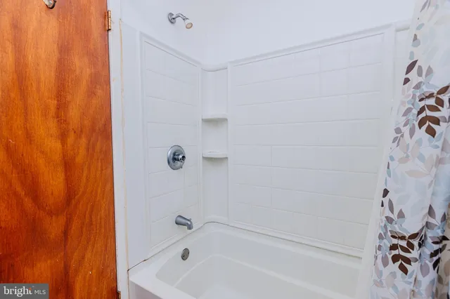 an empty room with windows and cabinet