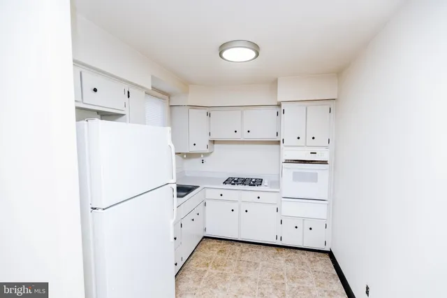 a white refrigerator freezer sitting inside of a kitchen