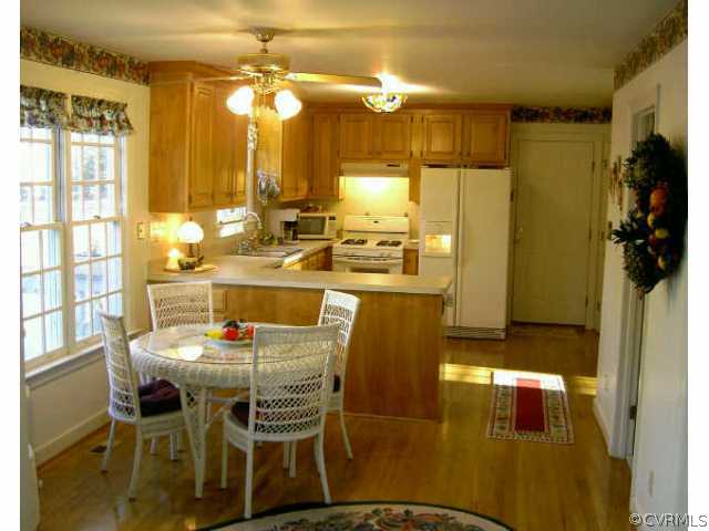 14001 Princess Mary Road Chesterfield, VA 23838 - Photo 7 of 10 a dining table with chairs and chandelier