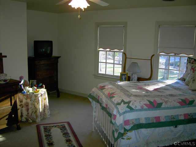 14001 Princess Mary Road Chesterfield, VA 23838 - Photo 9 of 10 a bedroom with a bed and a chandelier