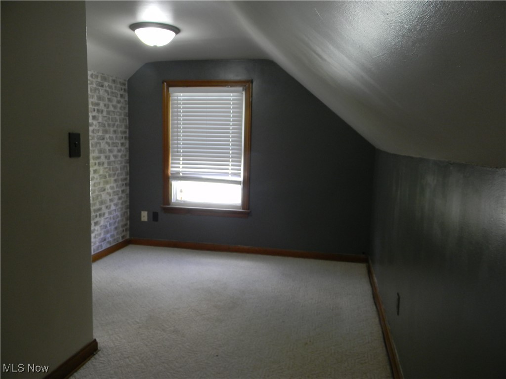 717 State Road Northwest Warren, OH 44483 - Photo 19 of 37 Bonus room with carpet and vaulted ceiling