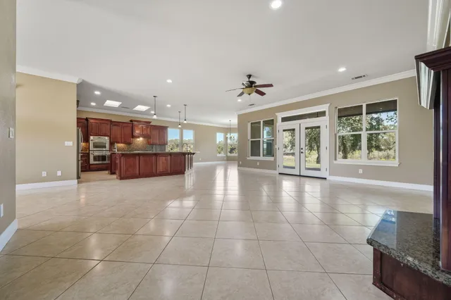 a kitchen with stainless steel appliances granite countertop a sink refrigerator and microwave