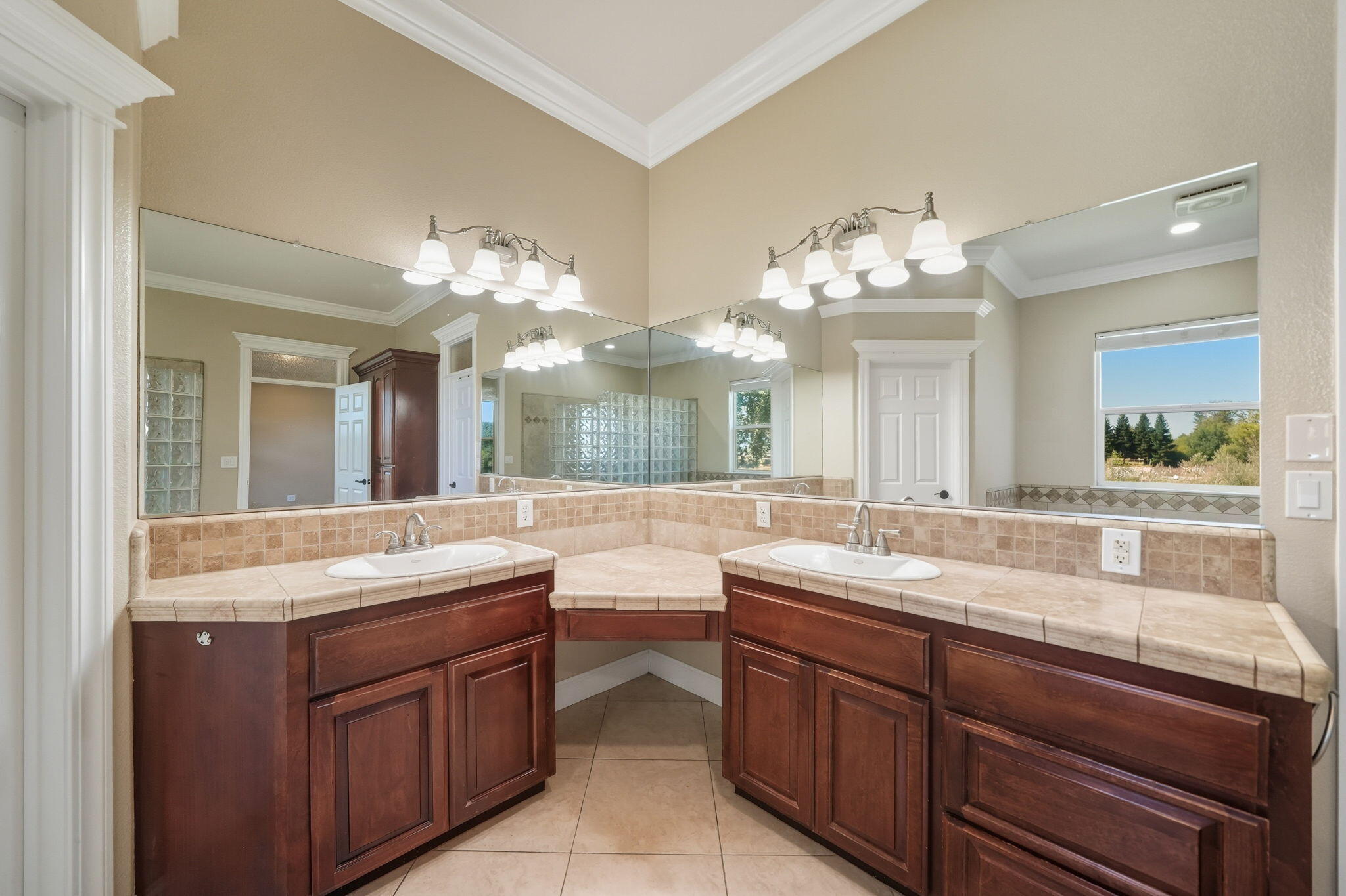 22894 Blue Jay Lane Anderson, CA 96007 - Photo 29 of 62 a bathroom with a granite countertop double vanity sink large mirror and cabinets