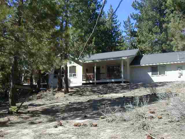 214 Highland Drive Stateline, NV 89449 - Photo 1 of 3 a view of a house with a yard and covered with trees