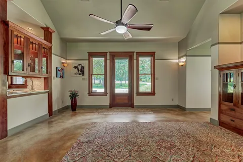 a view of an empty room with window and cabinet